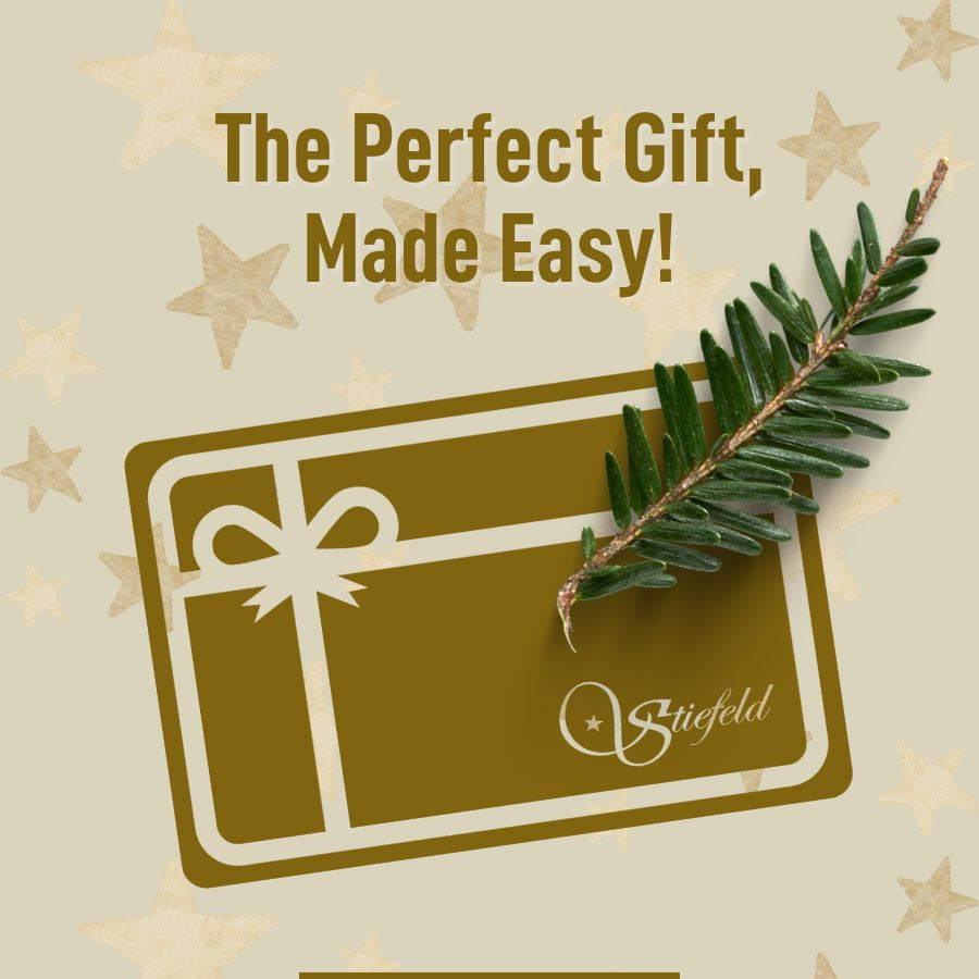 Gift card with Stiefel logo and Christmas tree branch on a beige background with stars.