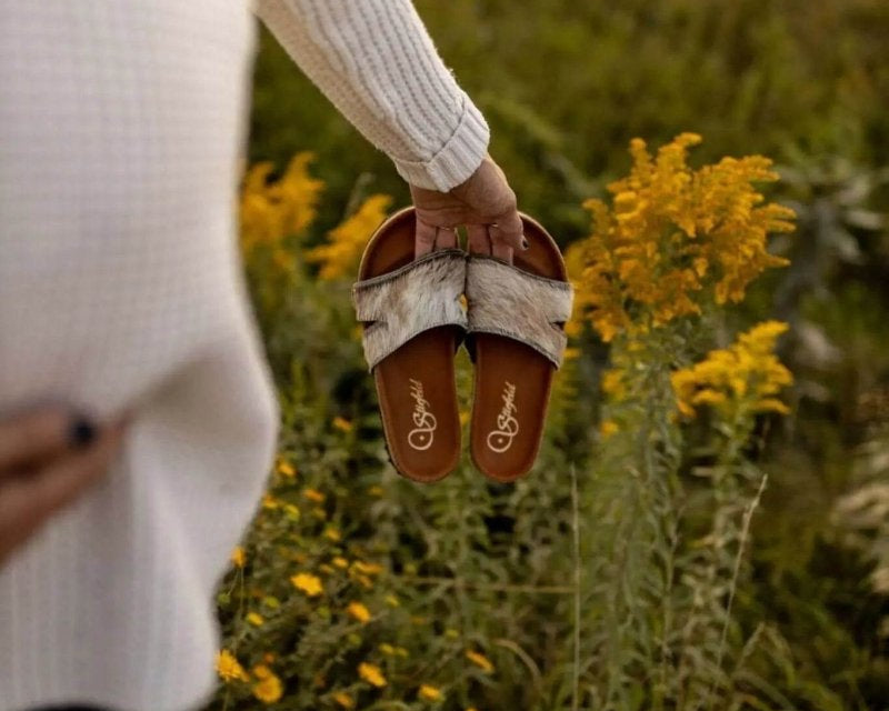 Tara cowhide sandals on cork footbed backdrop
