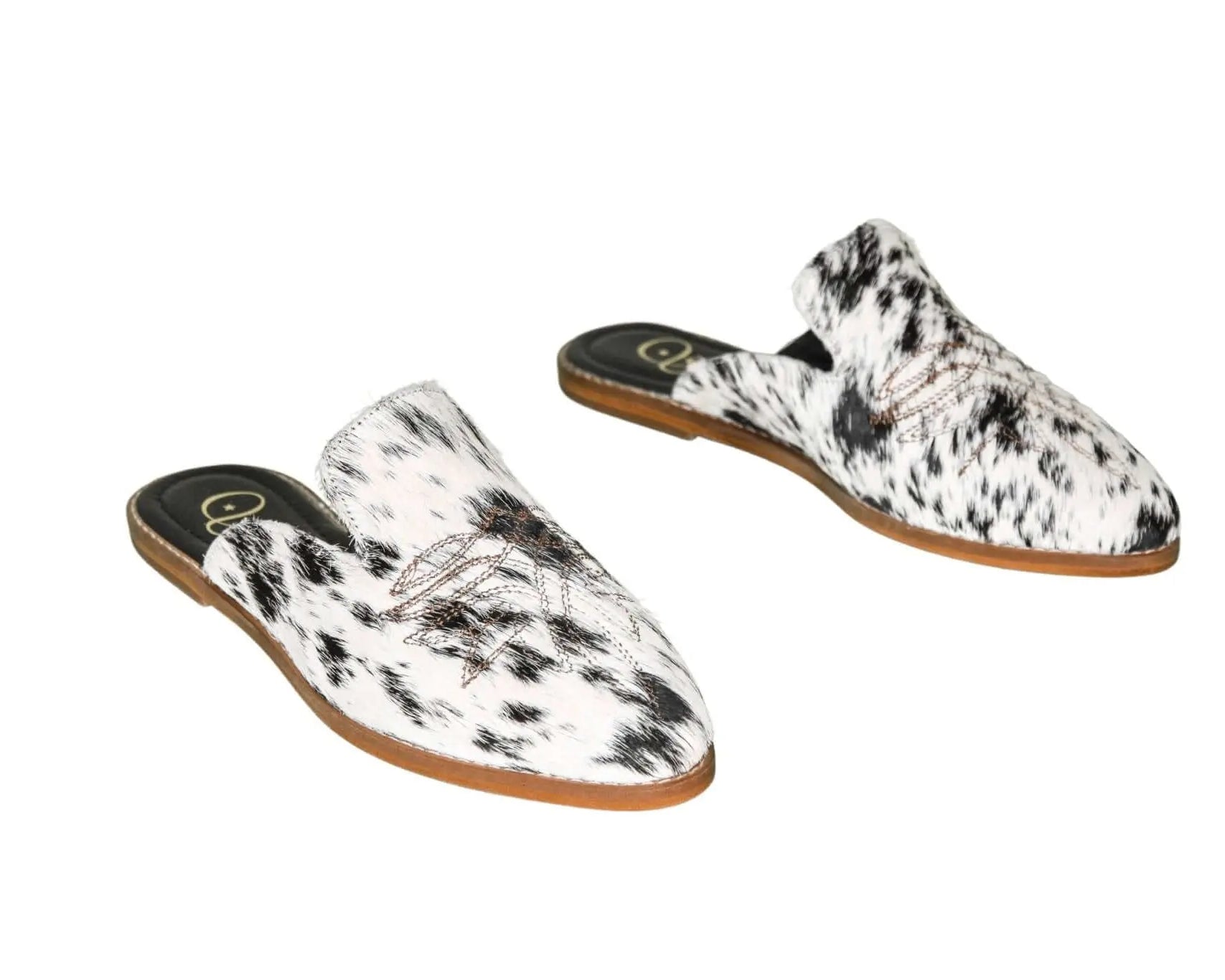 black and white hair-on-hide mules with leather sole