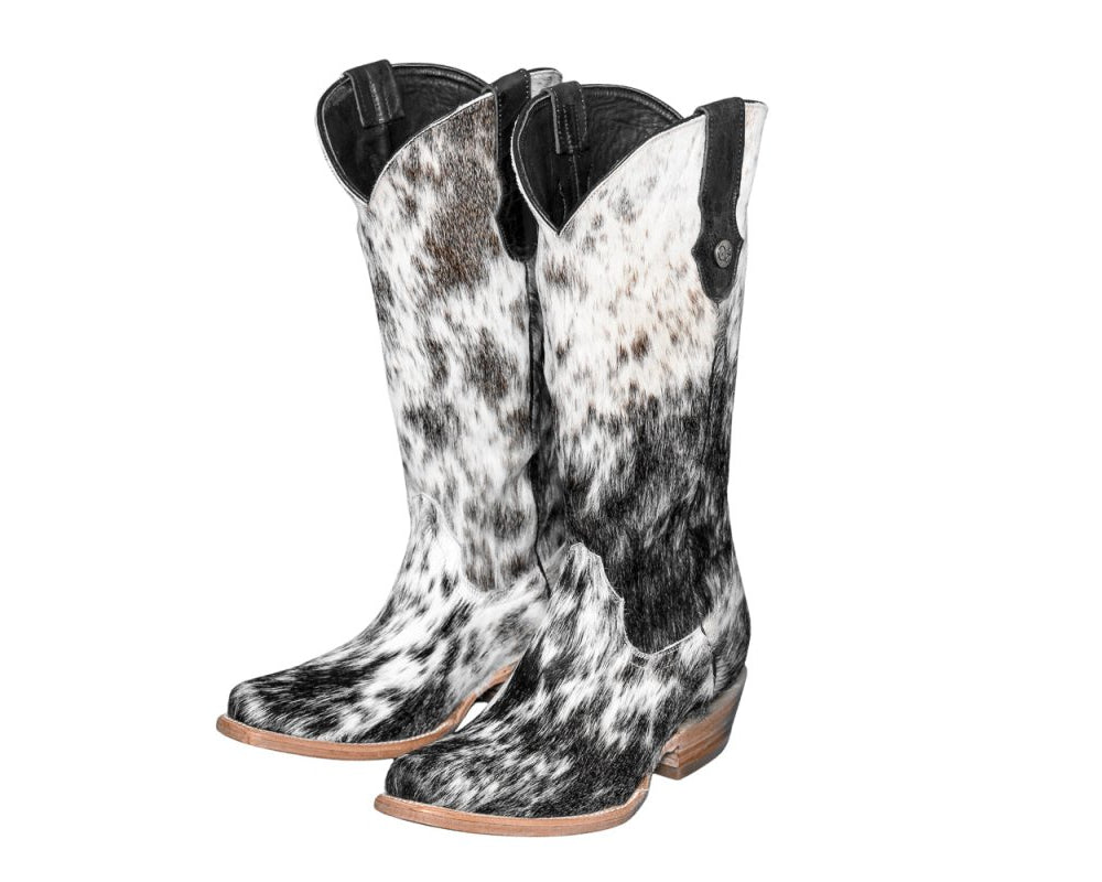 Black and white cowhide boots on a white background