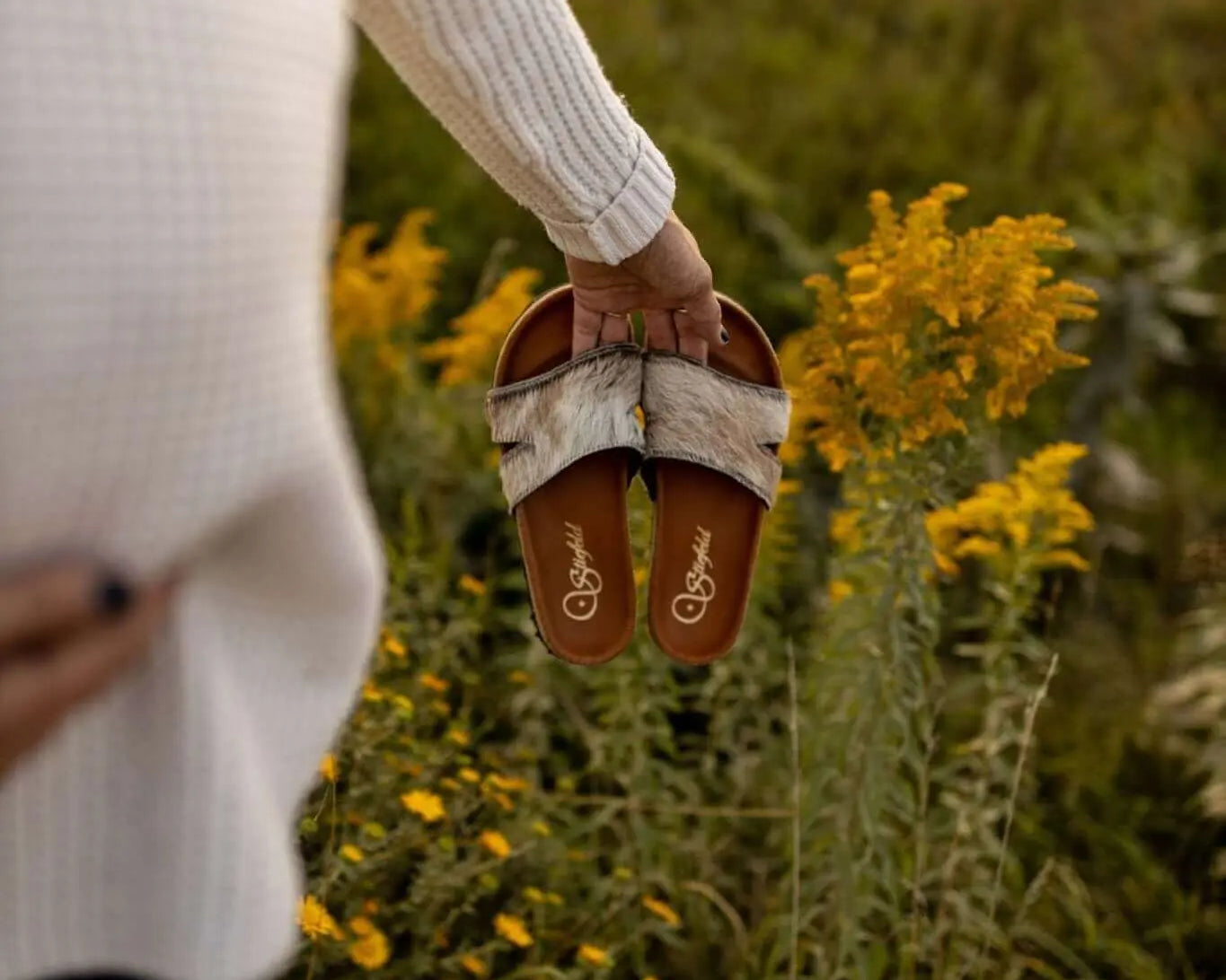 Tara cowhide sandals on cork footbed backdrop