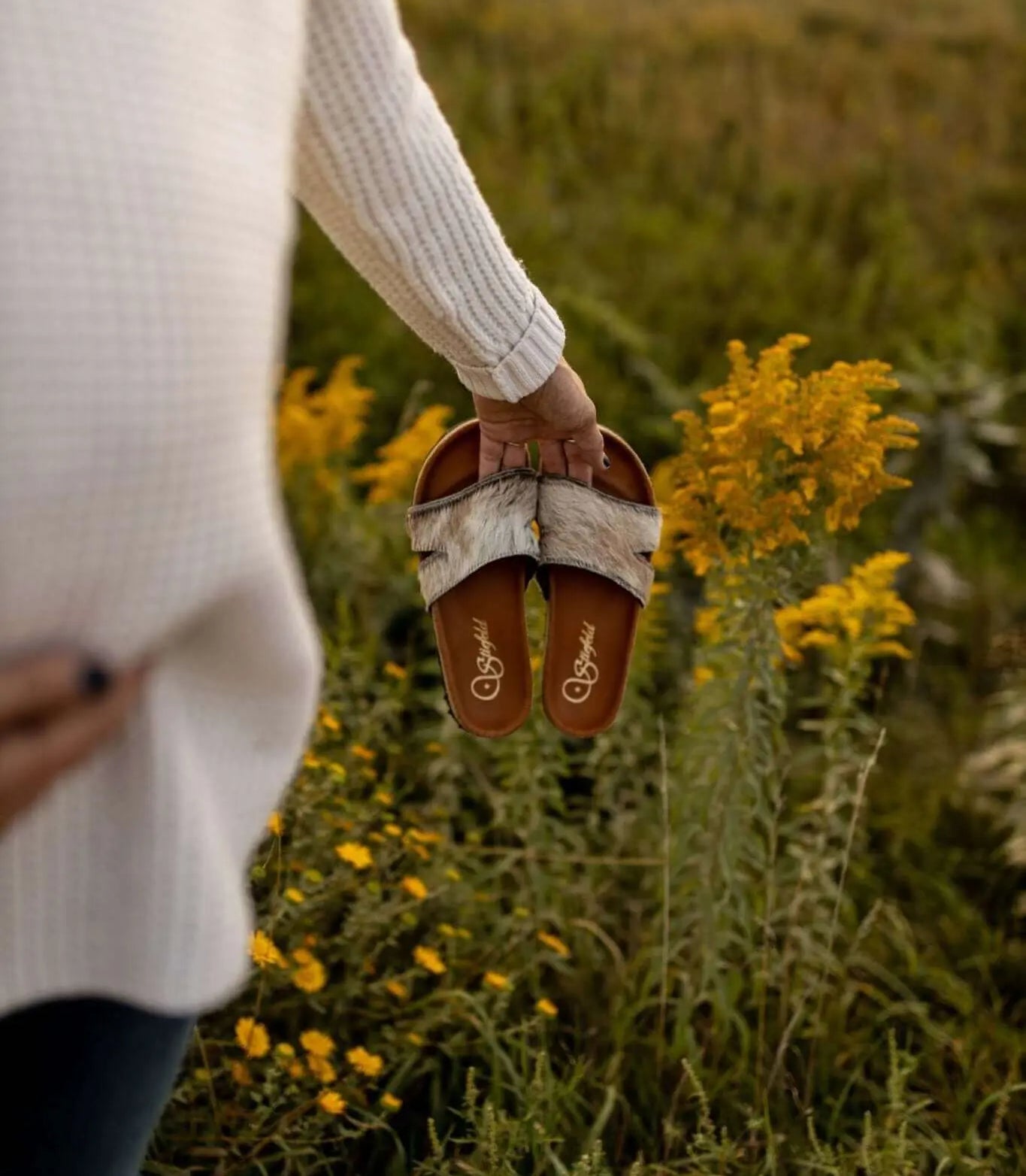 Tara cowhide sandals on cork footbed backdrop