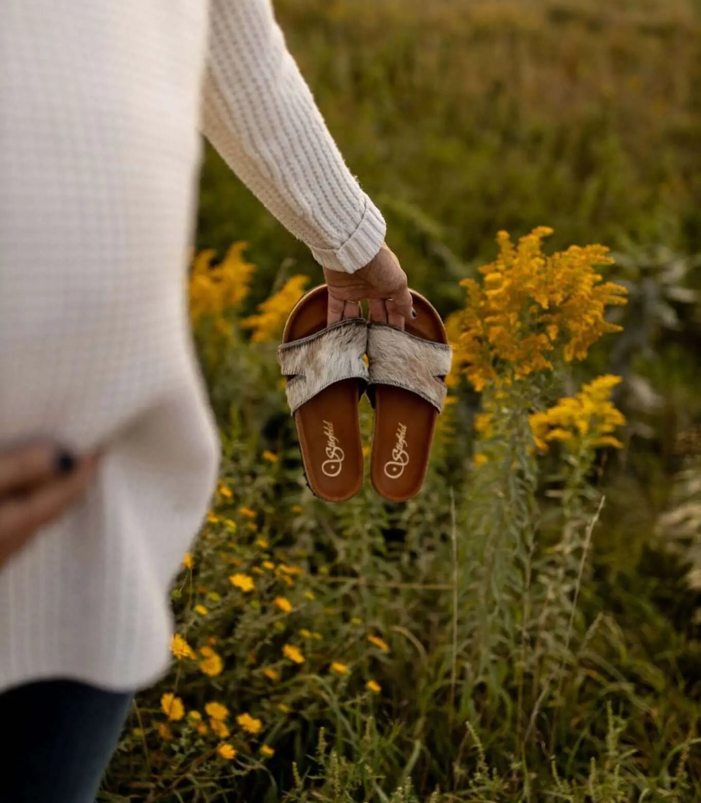 Tara cowhide sandals on cork footbed backdrop