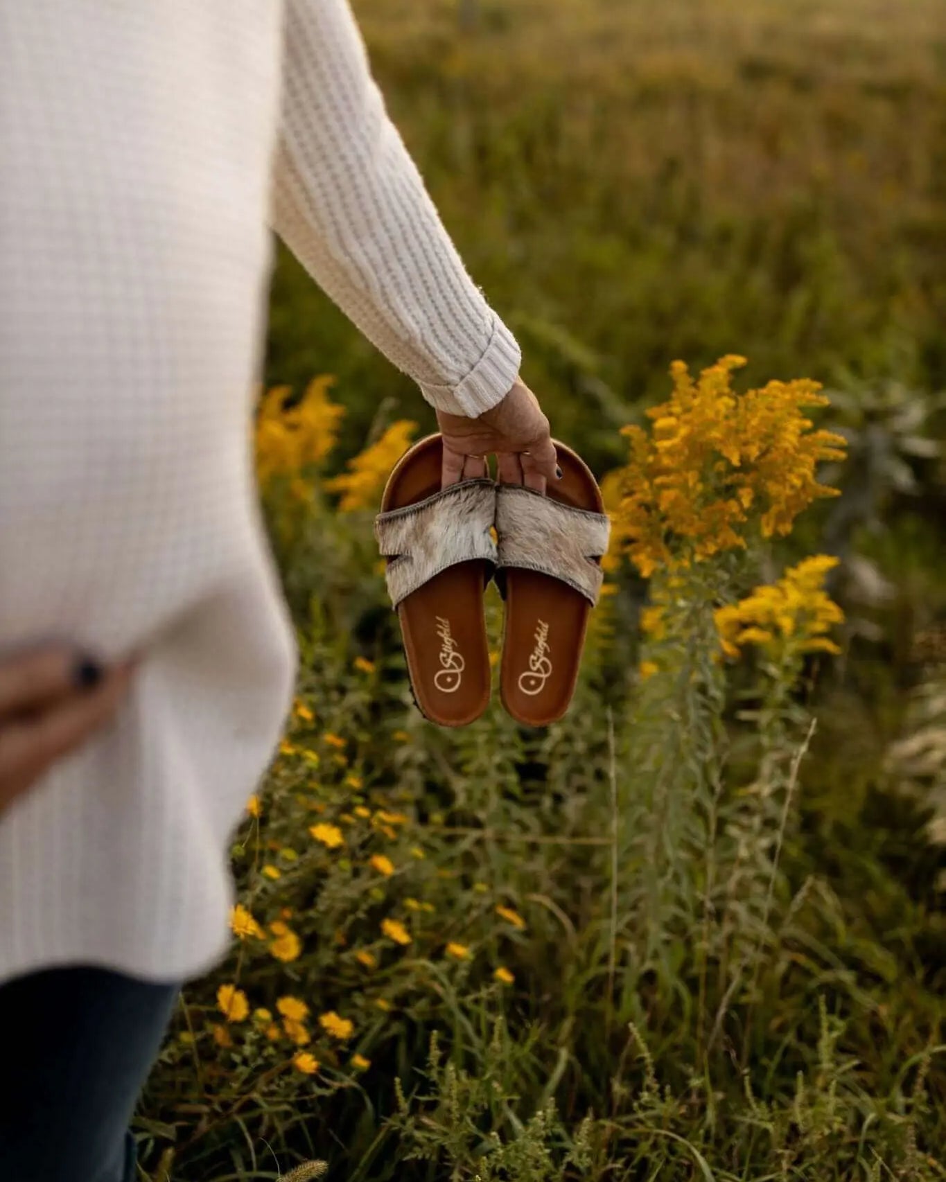 Tara cowhide sandals on cork footbed backdrop