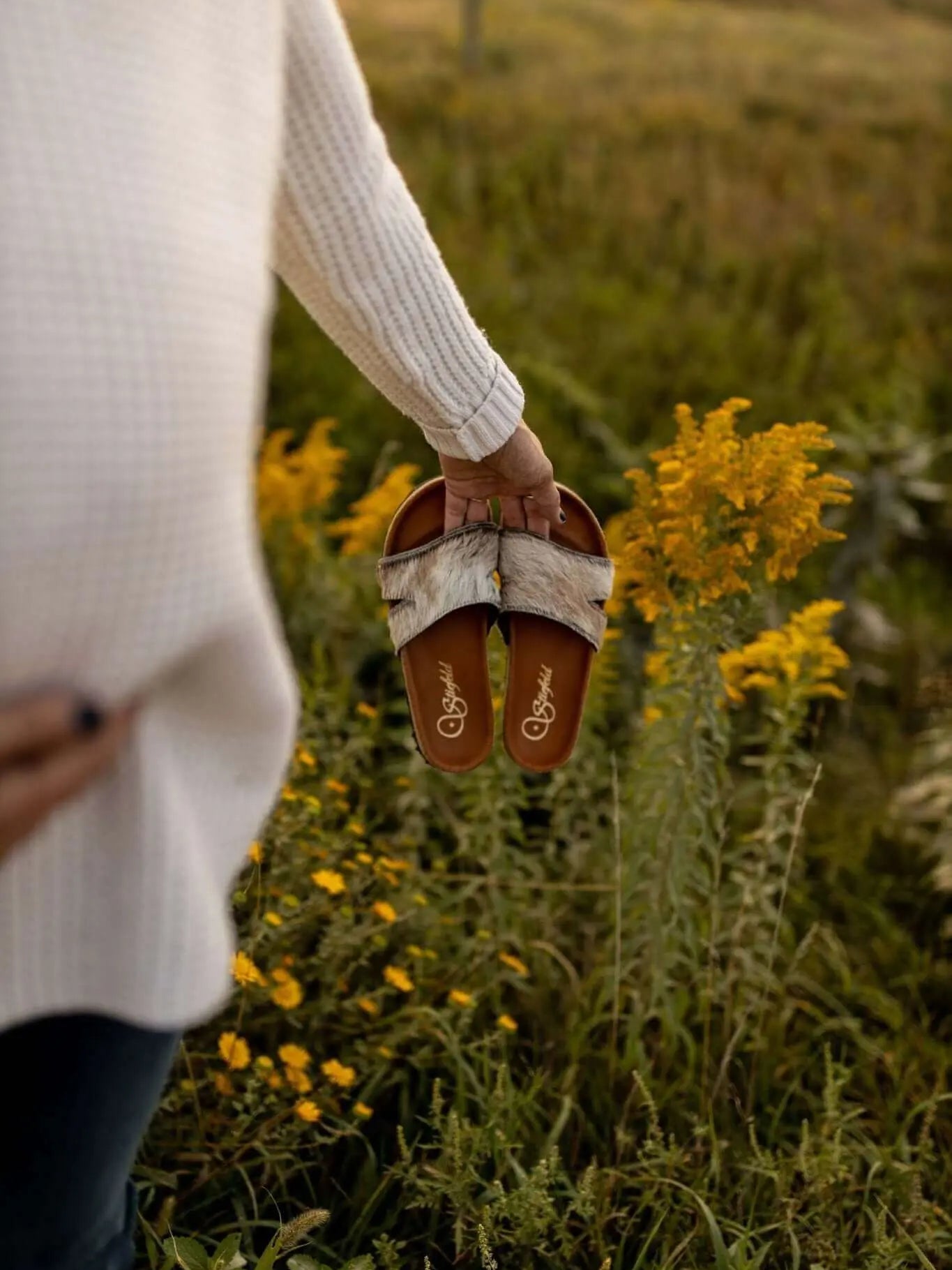 Tara cowhide sandals on cork footbed backdrop