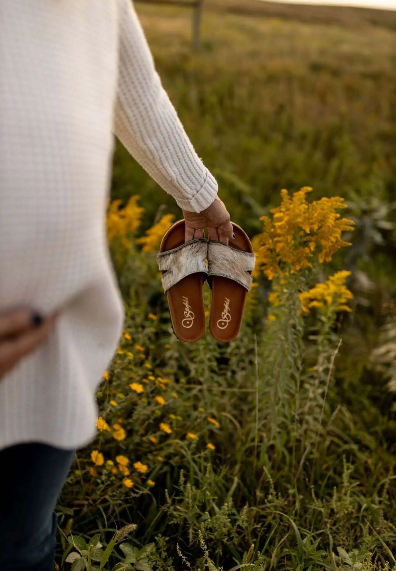 Tara cowhide sandals on cork footbed backdrop