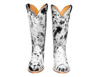 Pair of black and white cowhide boots with tan interior on a white background