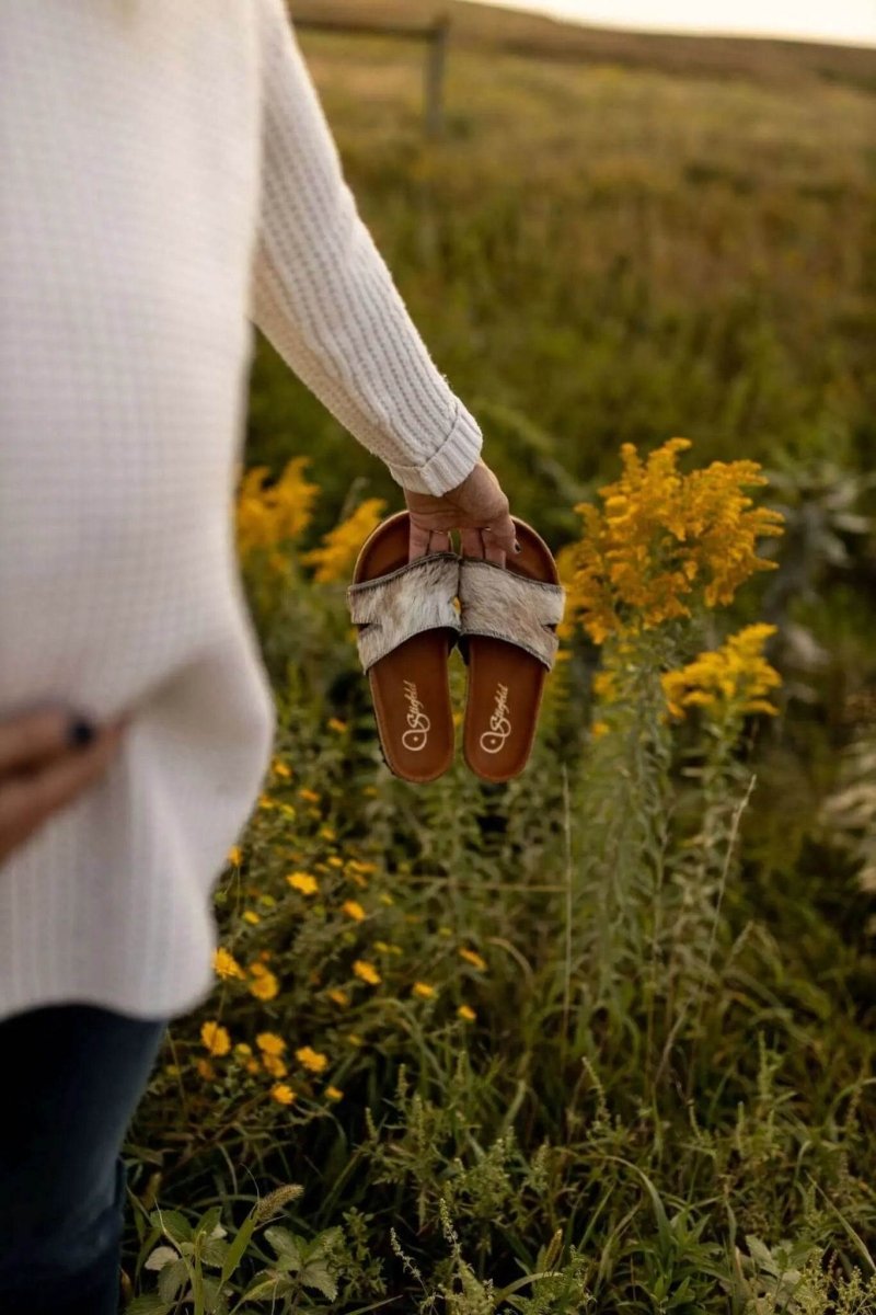 Tara cowhide sandals on cork footbed backdrop